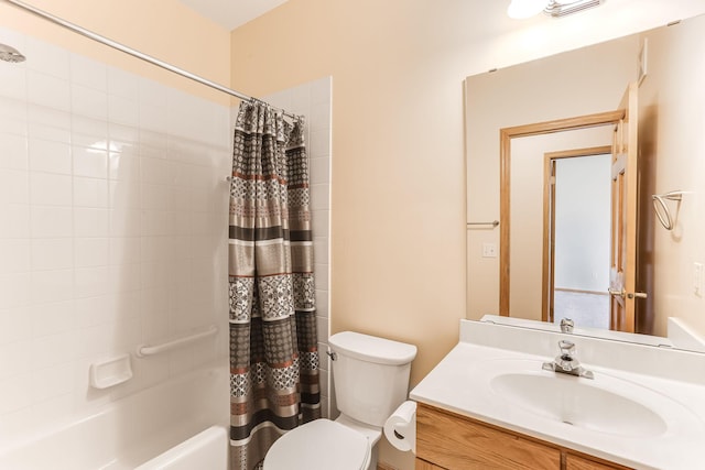 bathroom featuring toilet, shower / tub combo, and vanity