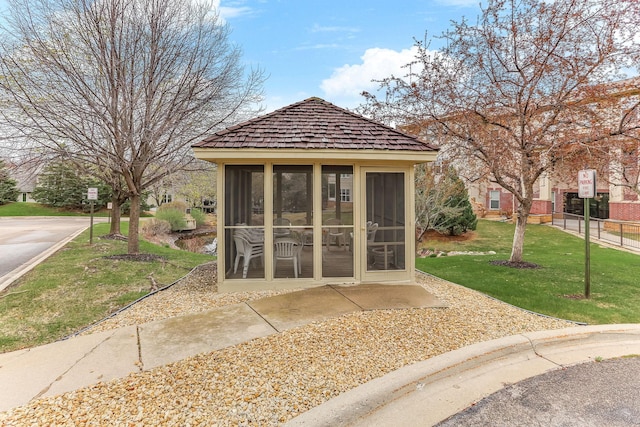 view of outbuilding featuring a sunroom