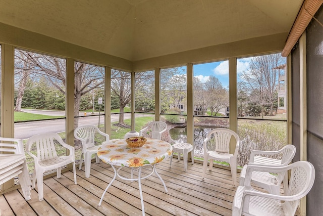 sunroom / solarium featuring a water view