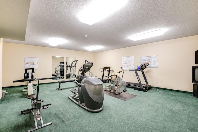 exercise room featuring baseboards, carpet flooring, and a textured ceiling