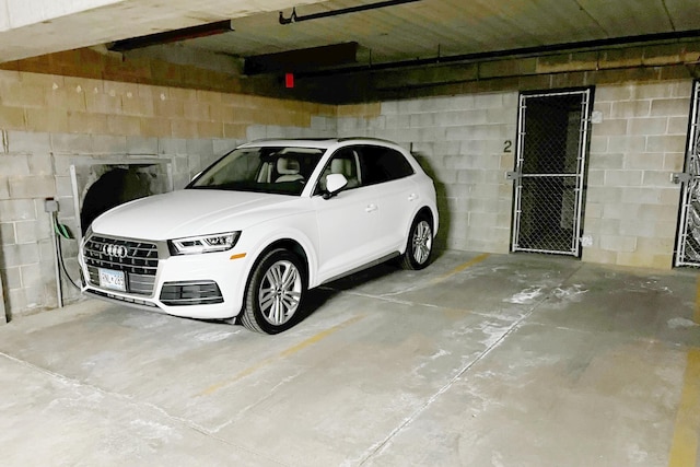 parking garage featuring concrete block wall