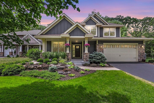 12566 Xylite St NE, Blaine, MN 55449 - craftsman inspired home with stone siding, driveway, a lawn, board and batten siding, and a garage