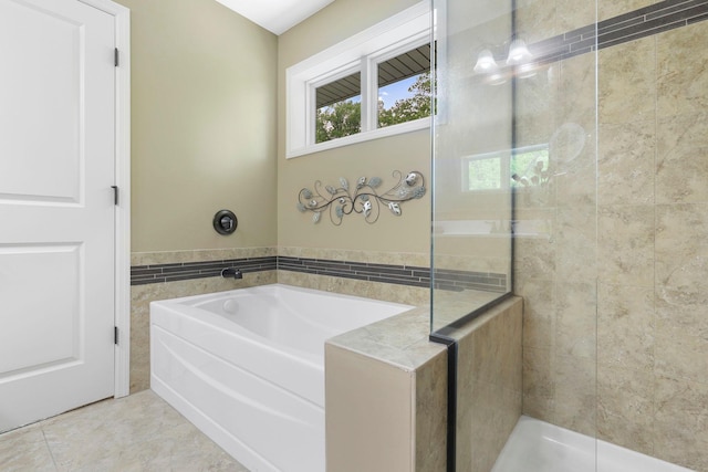 12566 Xylite St NE, Blaine, MN 55449 - bathroom featuring a garden tub, a tile shower, and tile patterned floors
