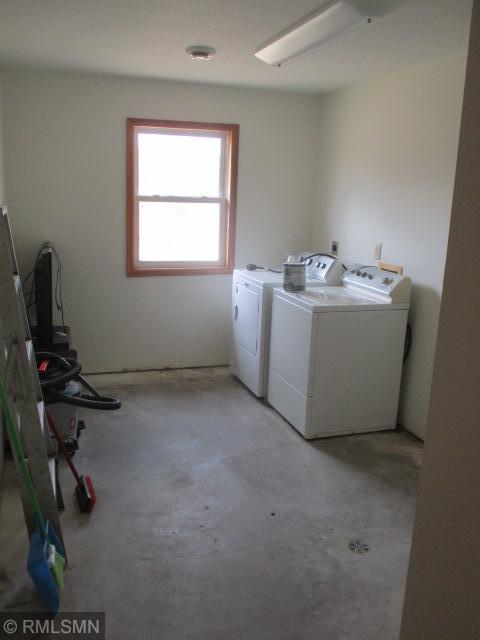 clothes washing area featuring washer and dryer and laundry area