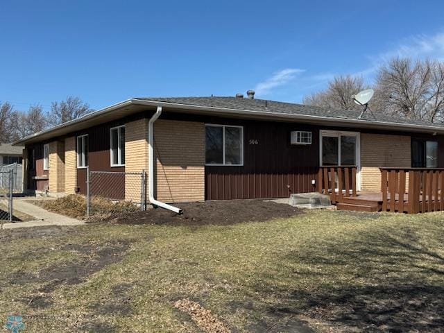 506 5th St E Unit 2, Fargo, ND 58078 - exterior space featuring a wooden deck, brick siding, and a front yard