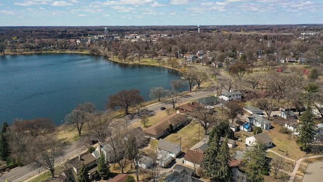 view of property location featuring a nearby body of water and nearby suburban area