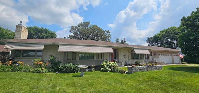 ranch-style home featuring brick siding, an attached garage, a front yard, and a chimney