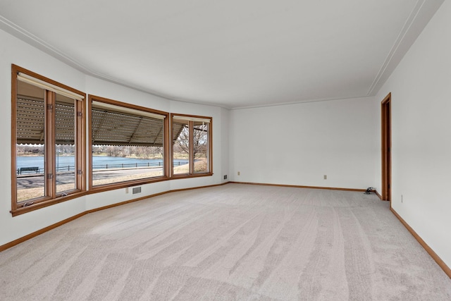 unfurnished room featuring light colored carpet and baseboards