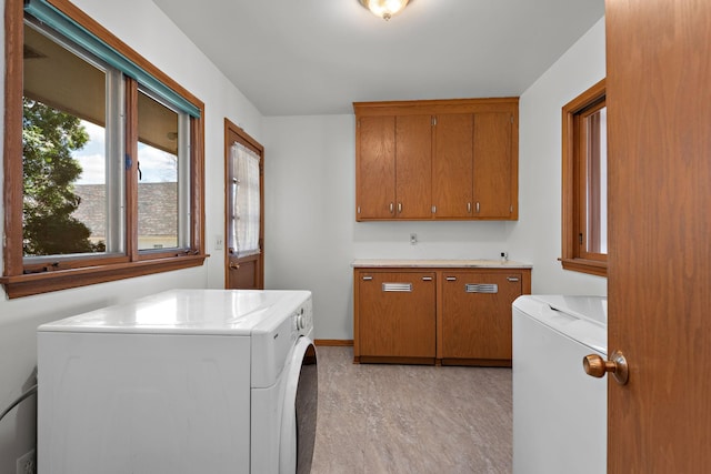 laundry area with washing machine and dryer and cabinet space