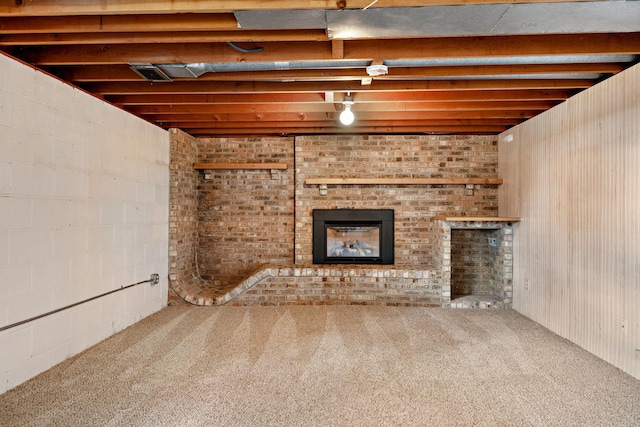 basement with carpet flooring and a brick fireplace