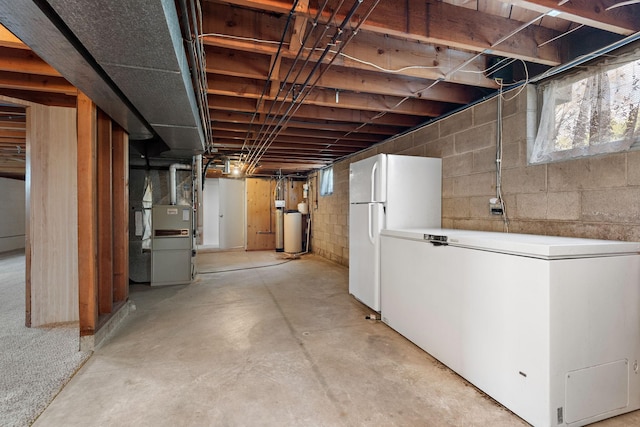basement featuring freestanding refrigerator, white refrigerator, a water softener system, and heating unit