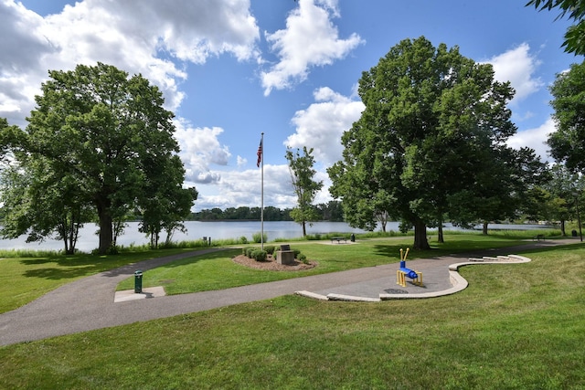 surrounding community featuring a water view and a yard