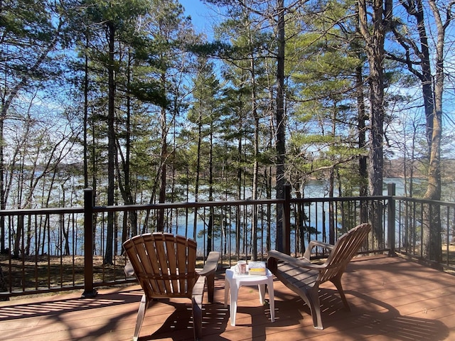 wooden terrace featuring a water view