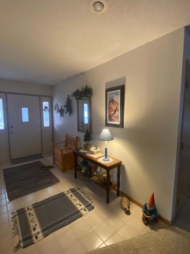 entrance foyer featuring tile patterned floors and baseboards