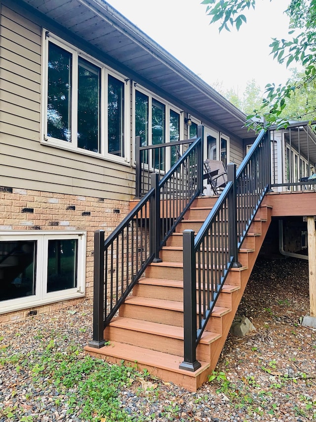 view of exterior entry with a wooden deck