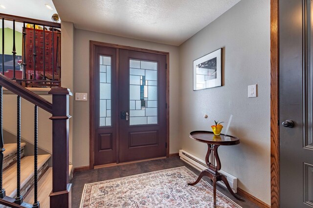 918 Division St, Elbow Lake, MN 56531 - entryway featuring wood finished floors, baseboards, a textured ceiling, and baseboard heating