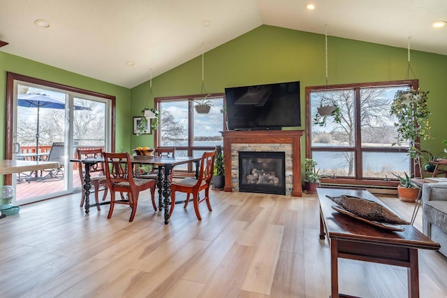 918 Division St, Elbow Lake, MN 56531 - dining area featuring a stone fireplace, light wood-style floors, recessed lighting, and high vaulted ceiling