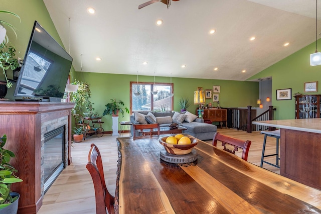 918 Division St, Elbow Lake, MN 56531 - dining room with lofted ceiling, light wood-style flooring, a glass covered fireplace, recessed lighting, and ceiling fan