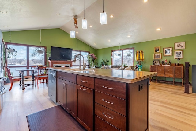 918 Division St, Elbow Lake, MN 56531 - kitchen featuring a sink, dishwasher, lofted ceiling, open floor plan, and a kitchen island with sink