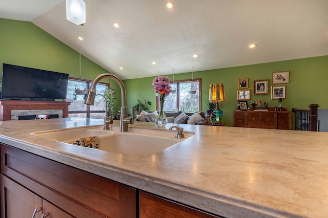 918 Division St, Elbow Lake, MN 56531 - kitchen with open floor plan, a sink, recessed lighting, lofted ceiling, and light countertops