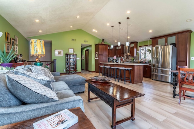 918 Division St, Elbow Lake, MN 56531 - living area featuring lofted ceiling, light wood-type flooring, and recessed lighting
