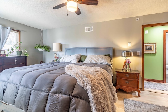 918 Division St, Elbow Lake, MN 56531 - bedroom featuring a textured ceiling, wood finished floors, and ceiling fan