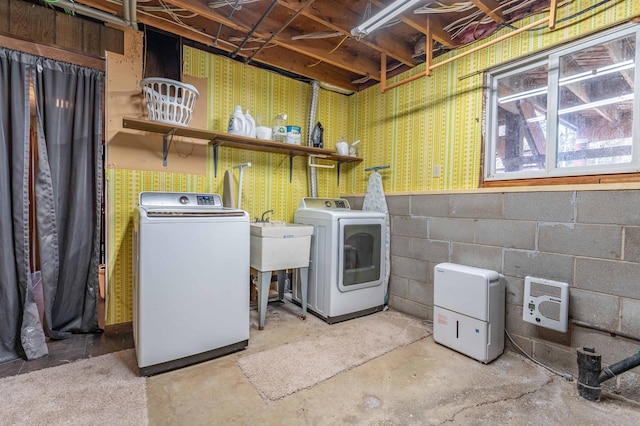 918 Division St, Elbow Lake, MN 56531 - laundry area featuring washing machine and clothes dryer, a sink, concrete block wall, heating unit, and wallpapered walls