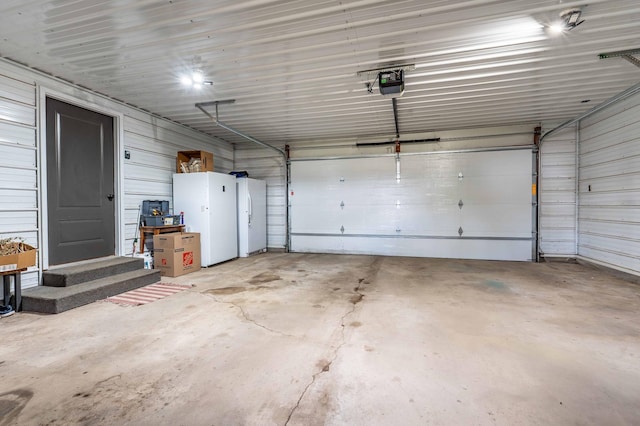 918 Division St, Elbow Lake, MN 56531 - garage with a garage door opener and freestanding refrigerator