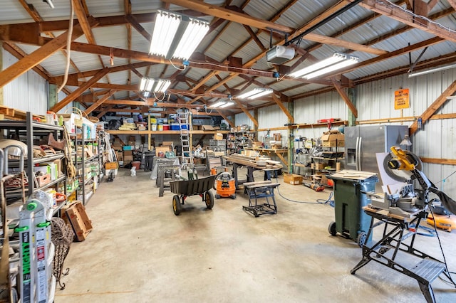 918 Division St, Elbow Lake, MN 56531 - garage with a garage door opener, a workshop area, and metal wall