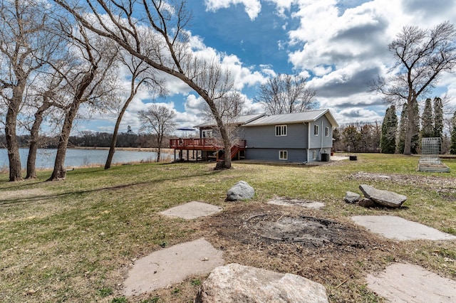 918 Division St, Elbow Lake, MN 56531 - view of grassy yard featuring a deck with water view and central air condition unit