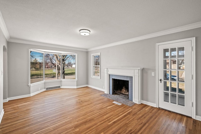 4240 Lake Road Ave, Robbinsdale, MN 55422 - unfurnished living room featuring visible vents, wood finished floors, a fireplace, and ornamental molding