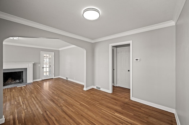 4240 Lake Road Ave, Robbinsdale, MN 55422 - unfurnished living room featuring arched walkways, visible vents, baseboards, hardwood / wood-style flooring, and ornamental molding