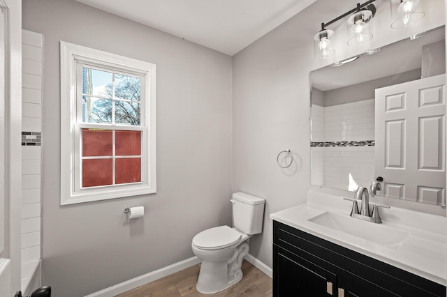 4240 Lake Road Ave, Robbinsdale, MN 55422 - full bathroom featuring wood finished floors, vanity, toilet, and baseboards