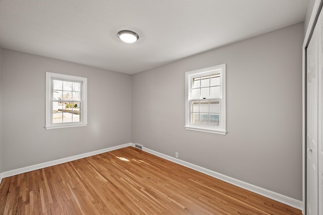 4240 Lake Road Ave, Robbinsdale, MN 55422 - spare room with baseboards, a healthy amount of sunlight, and light wood-style floors