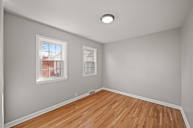 4240 Lake Road Ave, Robbinsdale, MN 55422 - spare room featuring visible vents, baseboards, and light wood-style floors