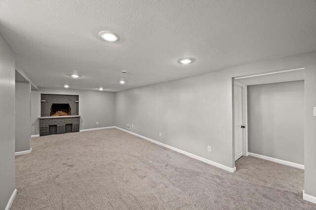 4240 Lake Road Ave, Robbinsdale, MN 55422 - below grade area featuring baseboards, a brick fireplace, carpet floors, and a textured ceiling