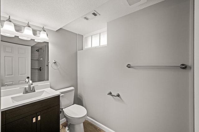 4240 Lake Road Ave, Robbinsdale, MN 55422 - full bathroom featuring visible vents, toilet, vanity, a textured ceiling, and a shower