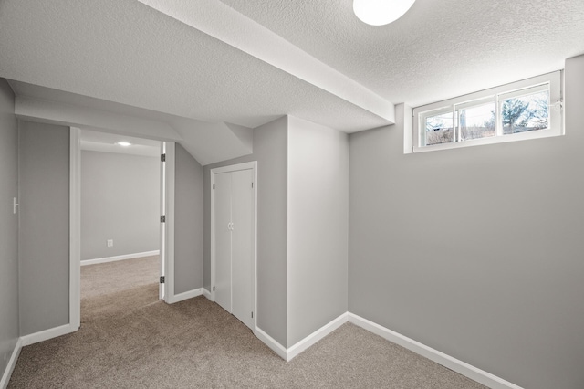4240 Lake Road Ave, Robbinsdale, MN 55422 - basement featuring carpet, a textured ceiling, and baseboards