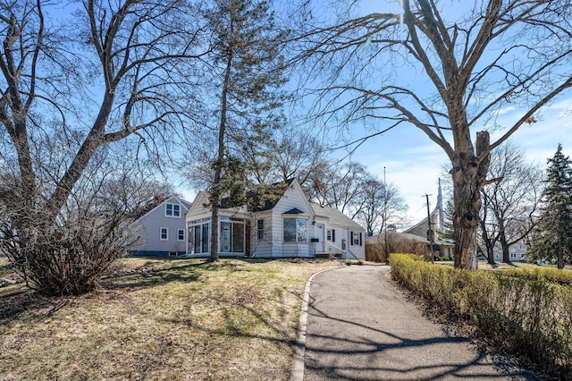 4240 Lake Road Ave, Robbinsdale, MN 55422 - view of front of house featuring a front lawn and a sunroom