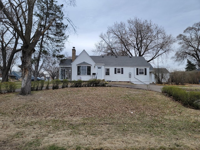 4240 Lake Road Ave, Robbinsdale, MN 55422 - view of front of house with a front yard and a chimney