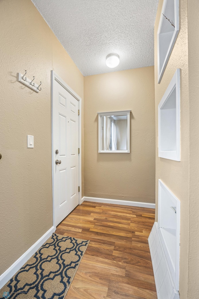 804 8th St N Unit 2, Fargo, ND 58102 - doorway with a textured ceiling and wood finished floors