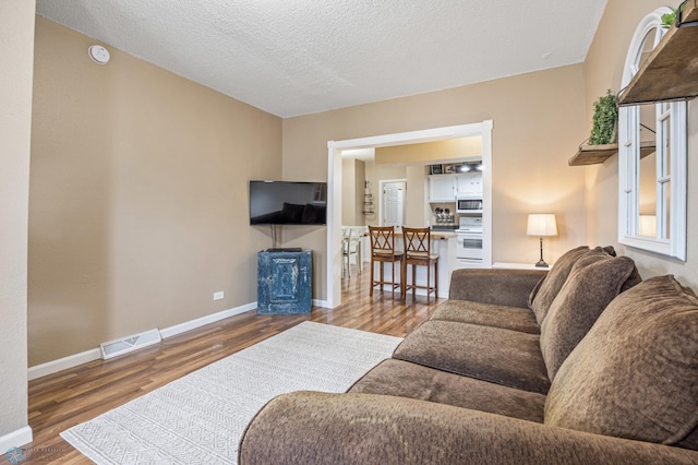 804 8th St N Unit 2, Fargo, ND 58102 - living area featuring wood finished floors and a textured ceiling