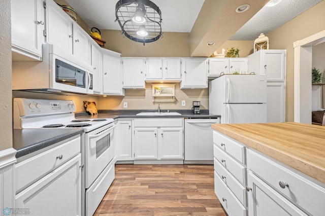 804 8th St N Unit 2, Fargo, ND 58102 - kitchen with white appliances, white cabinetry, light wood-type flooring, a textured ceiling, and recessed lighting