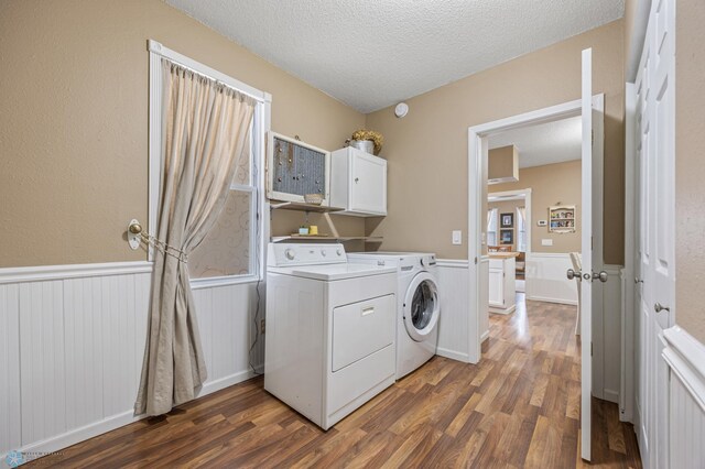 804 8th St N Unit 2, Fargo, ND 58102 - laundry area featuring washer and clothes dryer, wood finished floors, a wainscoted wall, a textured ceiling, and cabinet space