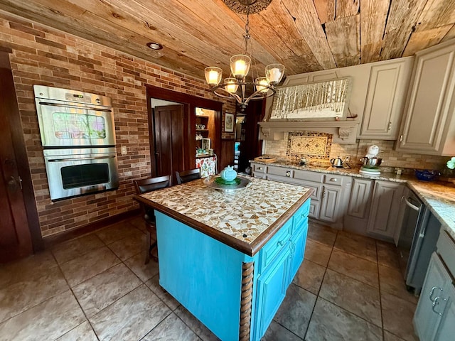 kitchen with wood ceiling, brick wall, a notable chandelier, and appliances with stainless steel finishes