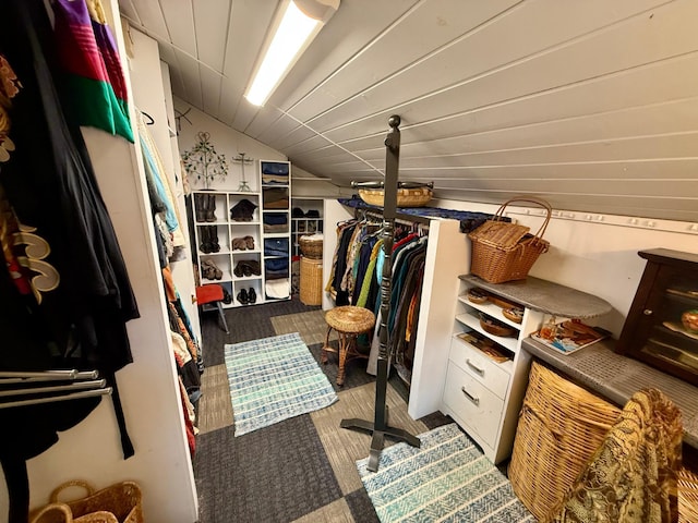 spacious closet with lofted ceiling and carpet