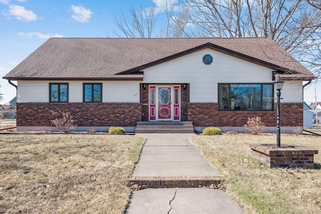 ranch-style home with a shingled roof and brick siding