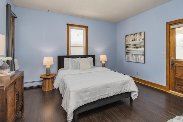 794 Laurel Ave, Saint Paul, MN 55104 - bedroom with baseboard heating, dark wood-style flooring, and baseboards