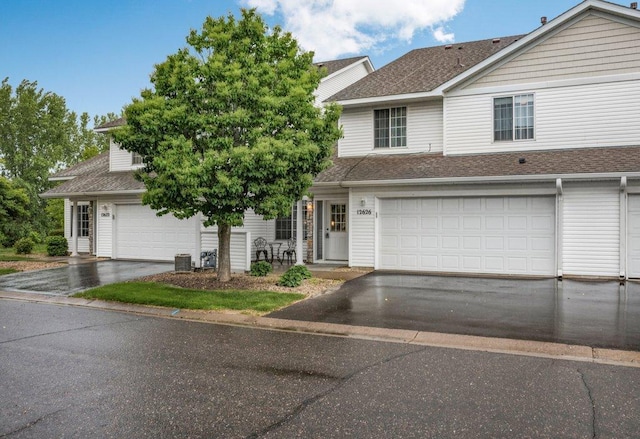 12626 43rd St NE, Saint Michael, MN 55376 - view of front facade with driveway, roof with shingles, and cooling unit