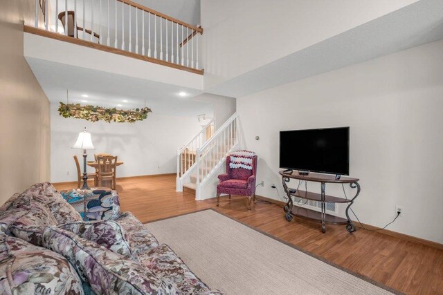 12626 43rd St NE, Saint Michael, MN 55376 - living room with wood finished floors, stairway, a towering ceiling, baseboards, and recessed lighting